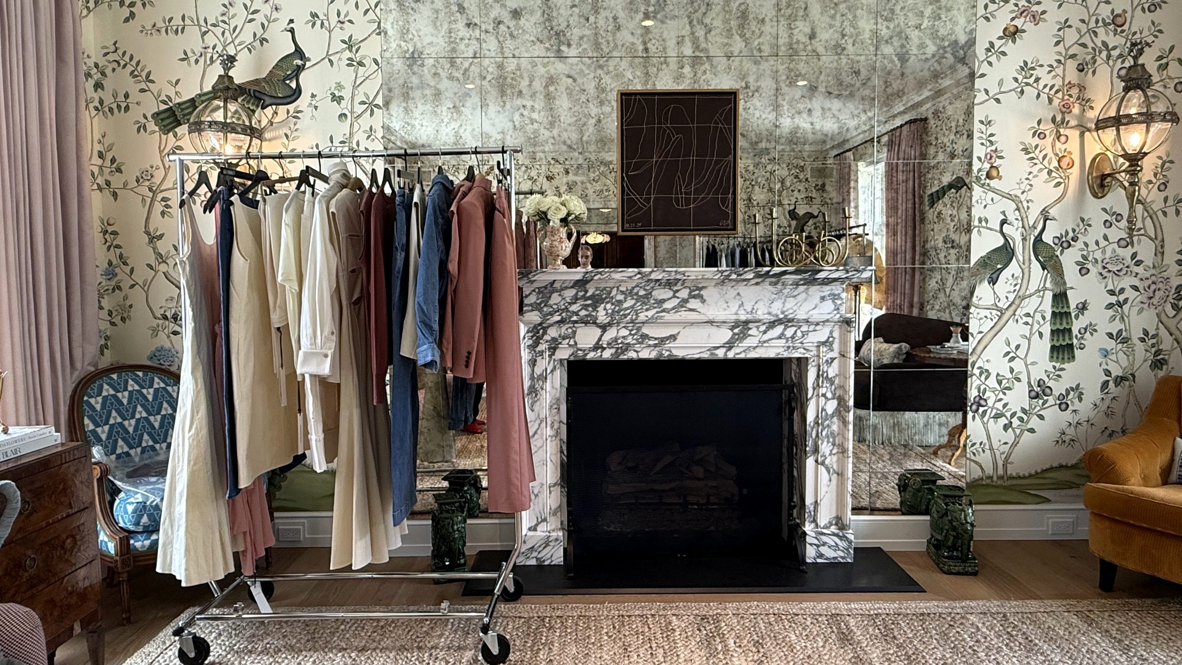 A rail of the collection beside a marble mantel in a chinoiserie salon