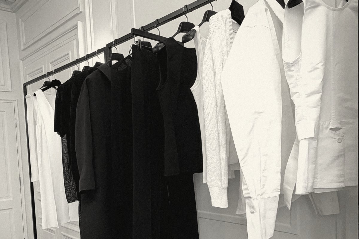 A rail of black and white pieces in a paneled salon