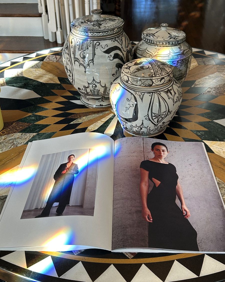 A collection lookbook open on an inlaid marble table
